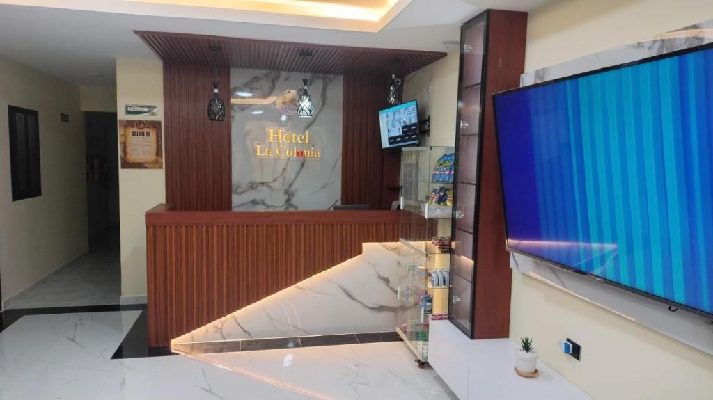 a lobby with a large screen in a building at Hotel y parqueadero La Colonia Inn in Socorro