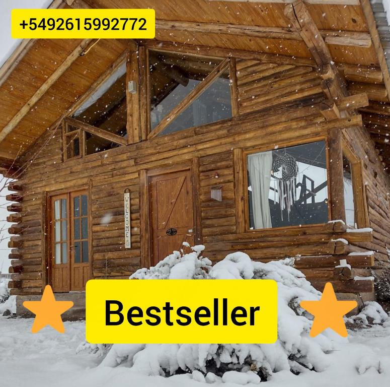 a log cabin in the snow with the words bestseller at Cabañas Isidris Uspallata in Uspallata