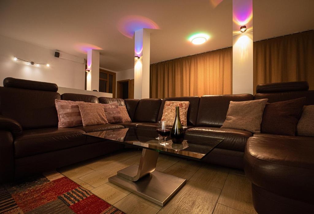 a living room with a couch and a table at Private Paradise Nuremberg in Nuremberg