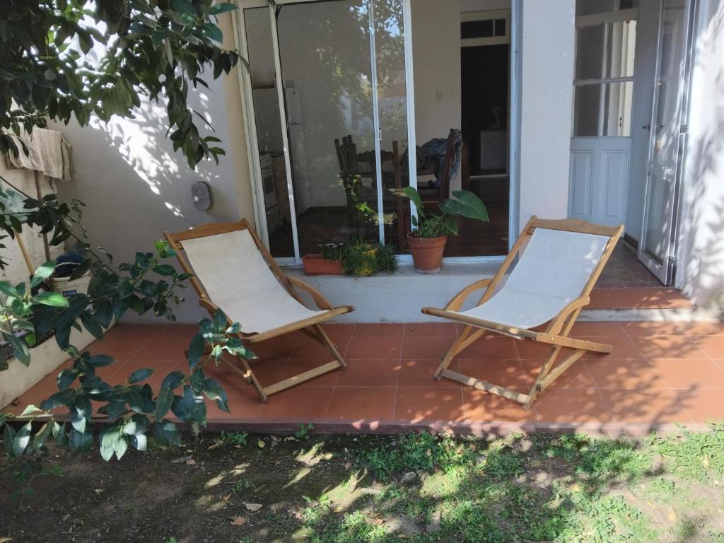 two chairs sitting on the porch of a house at Casa 1936 in Suipacha