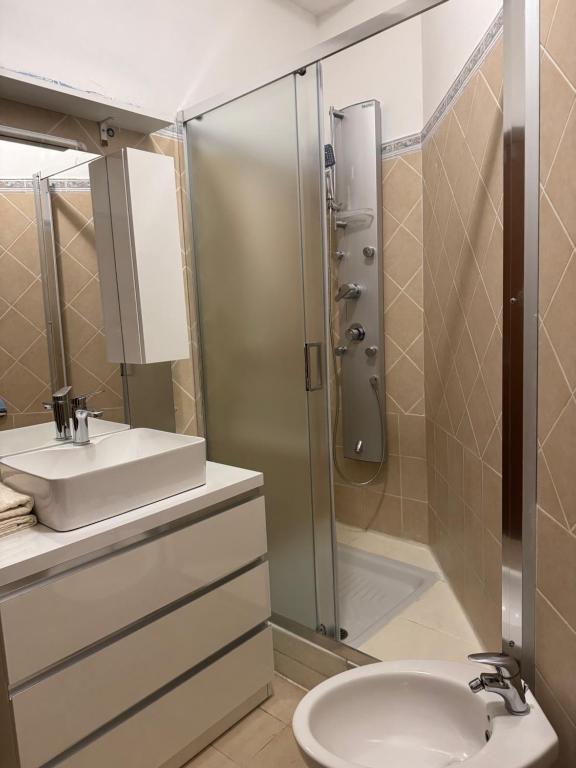 a bathroom with a shower and a sink and a toilet at Civitavecchia Port in Civitavecchia