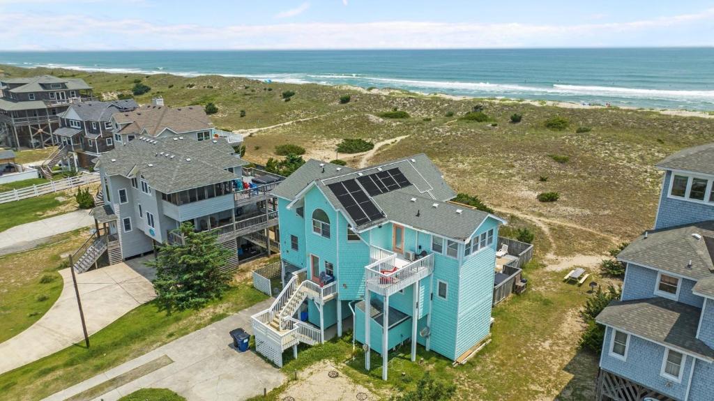an aerial view of a house with a solar roof at 8180 - Looney Dunes in Waves