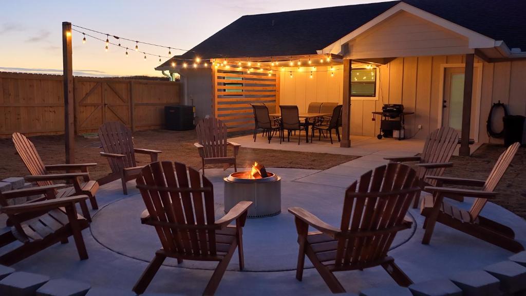 a group of chairs and a fire pit on a patio at Group Ready! 3BR Home Near WinStar in Thackerville