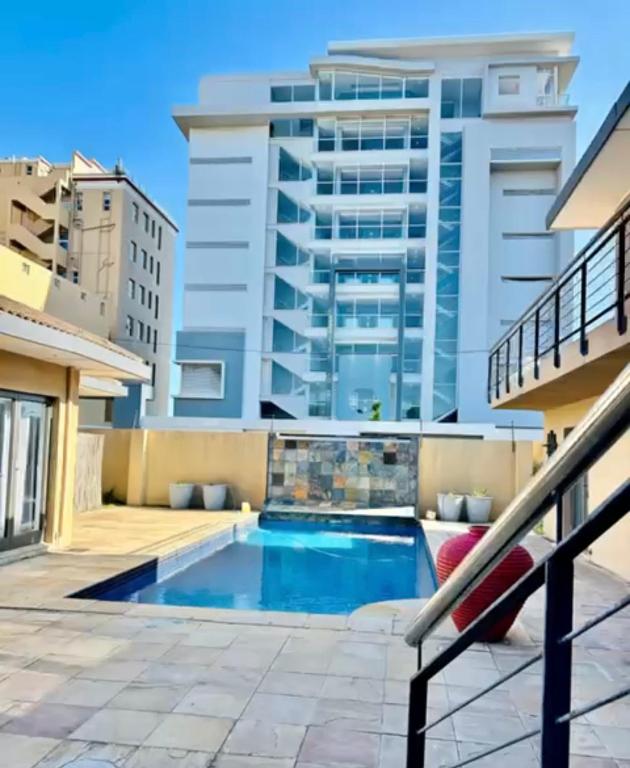 a swimming pool on the roof of a building at The Folkestone Guest House in Gqeberha
