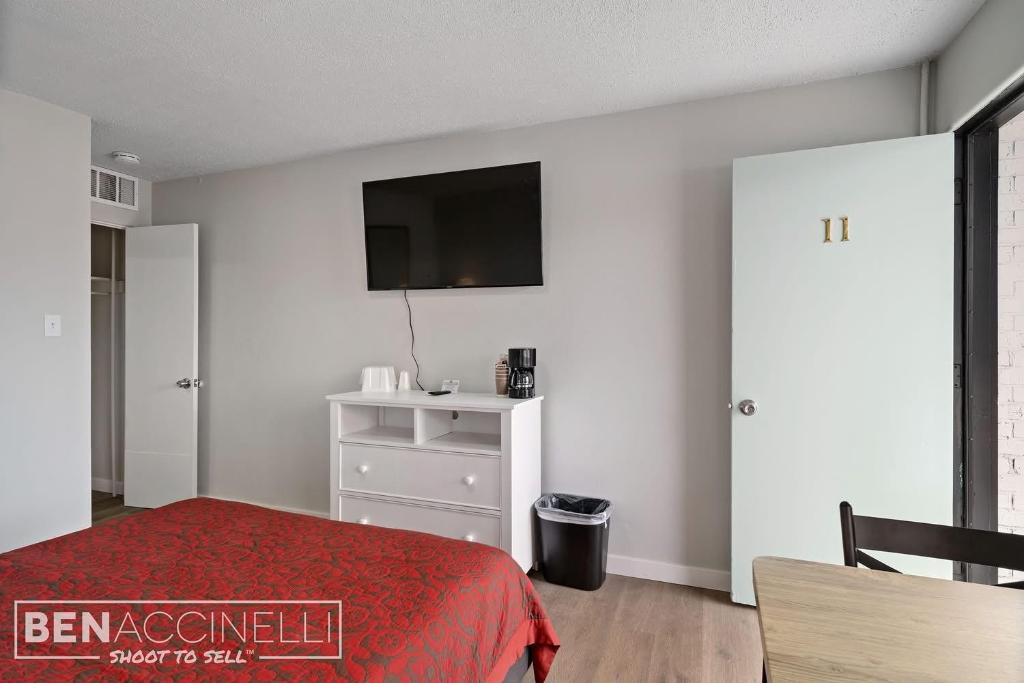 a bedroom with a bed and a tv on the wall at The mint in Rock Springs