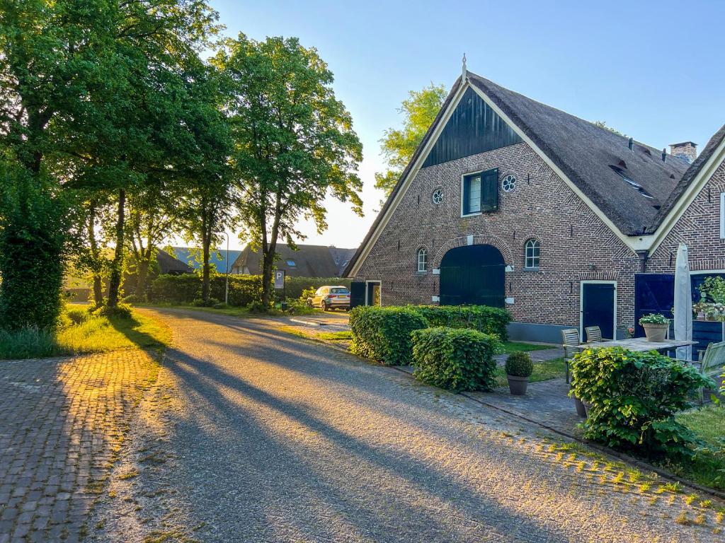 a brick house with a driveway in front of it at De Rheezer Kamer in Hardenberg
