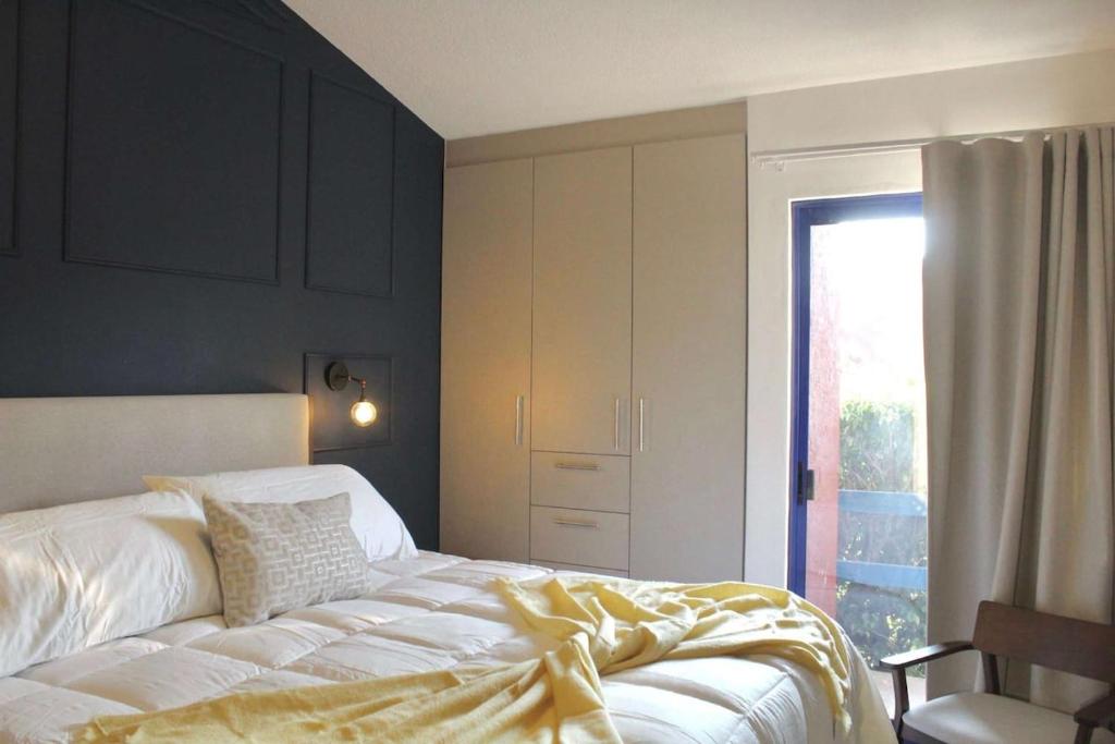 a bedroom with a bed with a yellow blanket on it at Charming Suite Pool AC Location 10C in San Pablo