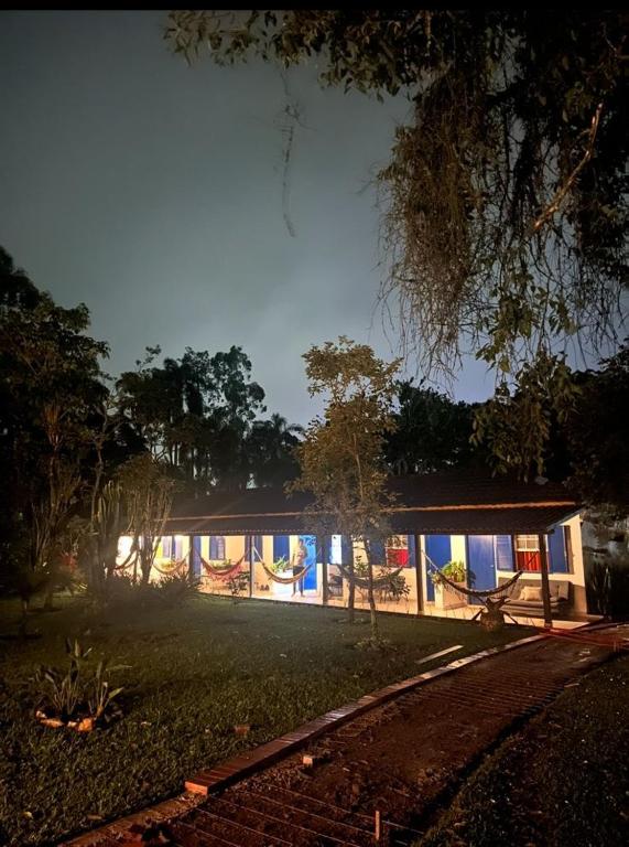 a house is lit up at night at Pousada do Campo in Ipiabas