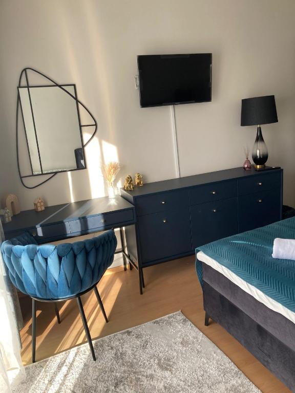 a bedroom with a desk with a mirror and a bed at Willa Zakopane Center in Zakopane