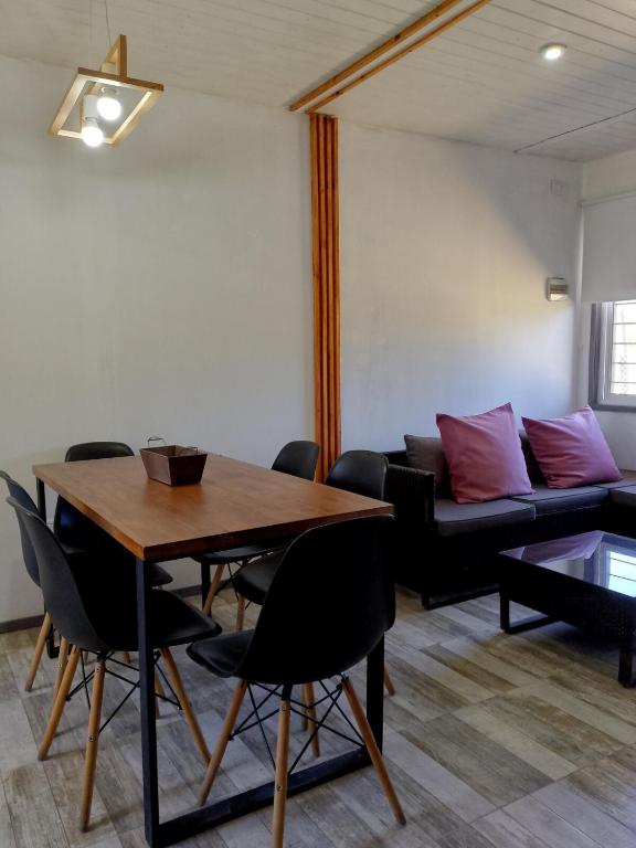 a living room with a table and a couch at Casa Uno in Paso de la Patria