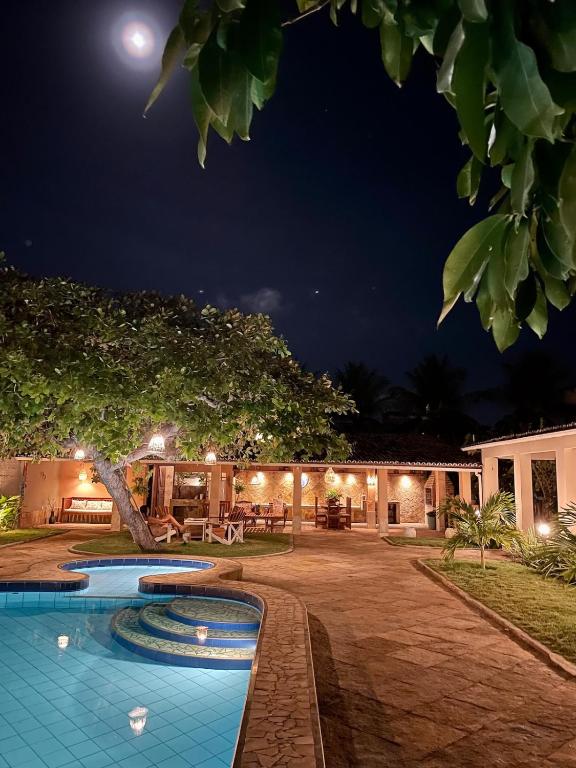 a resort with a swimming pool at night at Villa Wiktor Paracuru in Paracuru