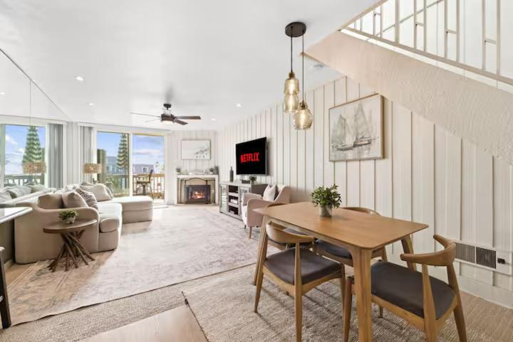 a living room with a table and a couch at Beachfront Resort-sunset views deck & luxe king in Oceanside