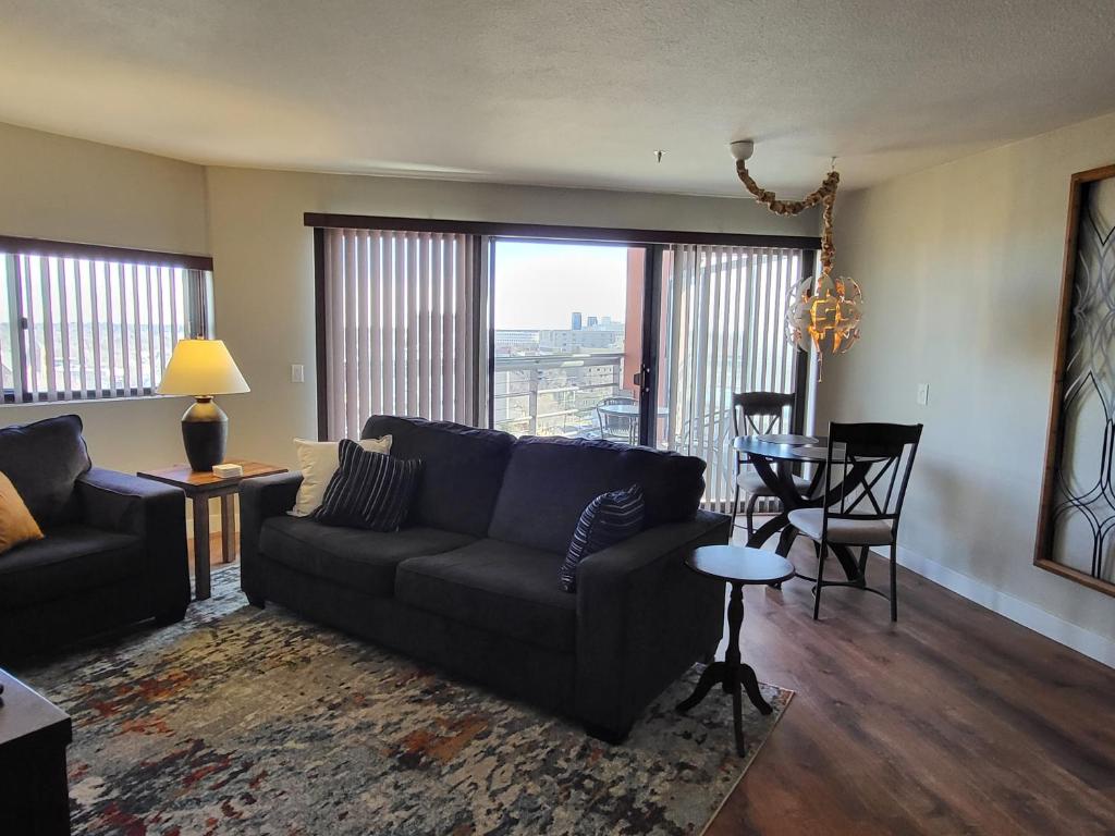 a living room with a couch and a table at Comfortable 1 Bed 1 Bath Loft in Uptown Denver in Denver
