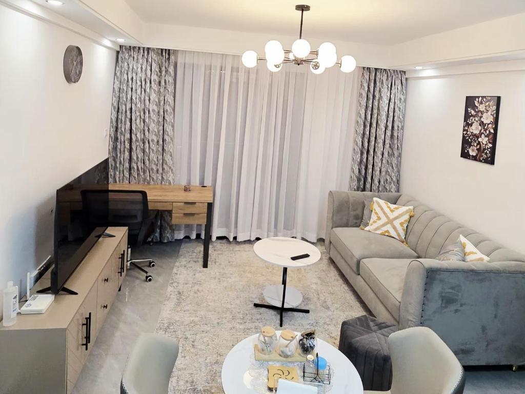 a living room with a couch and a table at Purplehaze Place in Nairobi