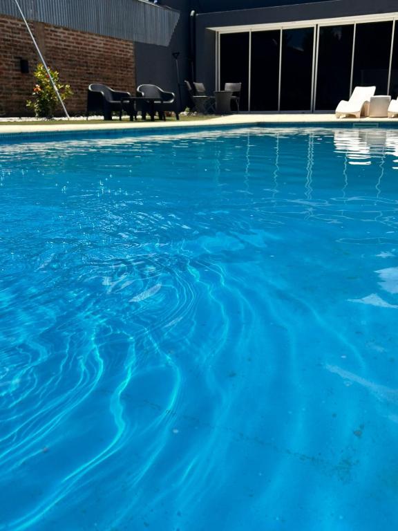 a large swimming pool with blue water at Residencia Dos Soles 2.0 in Resistencia
