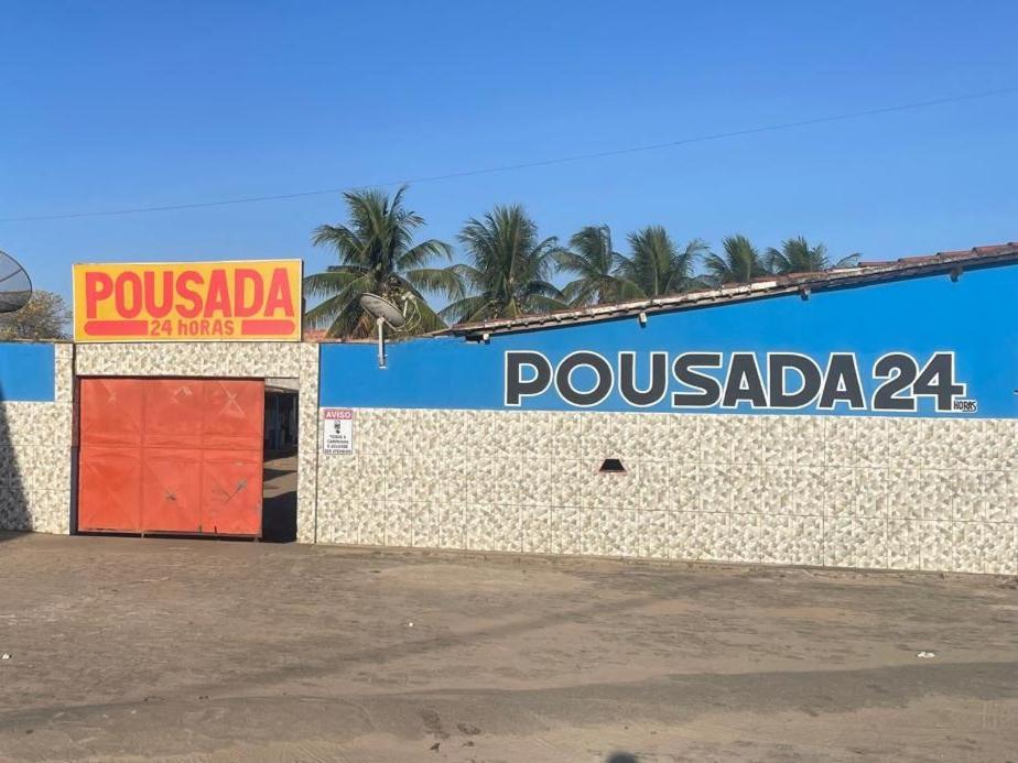 a building with a sign on the side of it at Pousada Rosario in Malhada dos Bois