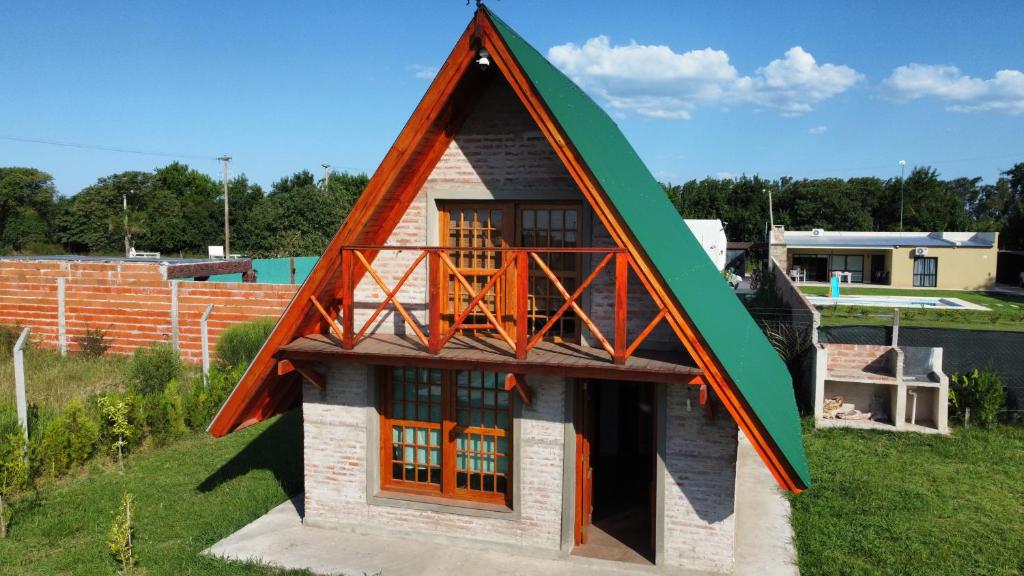 a small house with a gambrel roof at Cabaña don Cencio in San Pedro