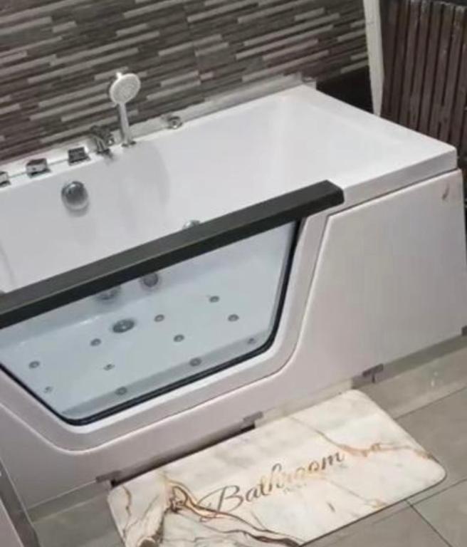 a white stove top oven with a towel on the floor at Apartamento Deluxe city in Burgos