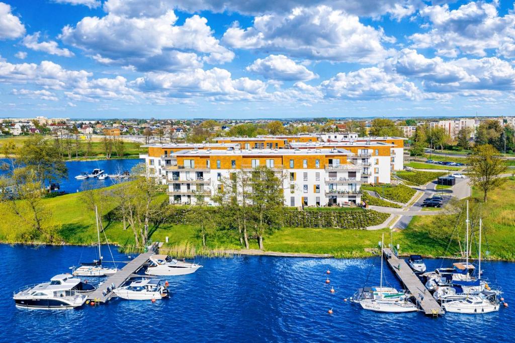 a group of boats are docked in a marina at Marina Relax - widok na jezioro, parking podziemny, winda, Netflix, TV55" in Iława