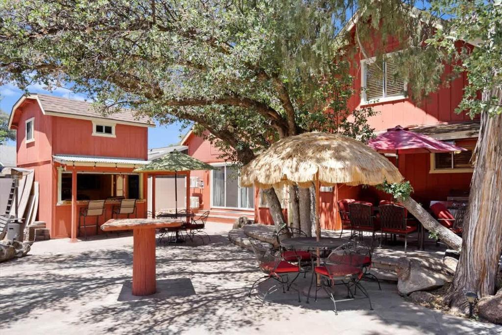 a patio with a table and chairs under a tree at Timberland Hideaway in Payson