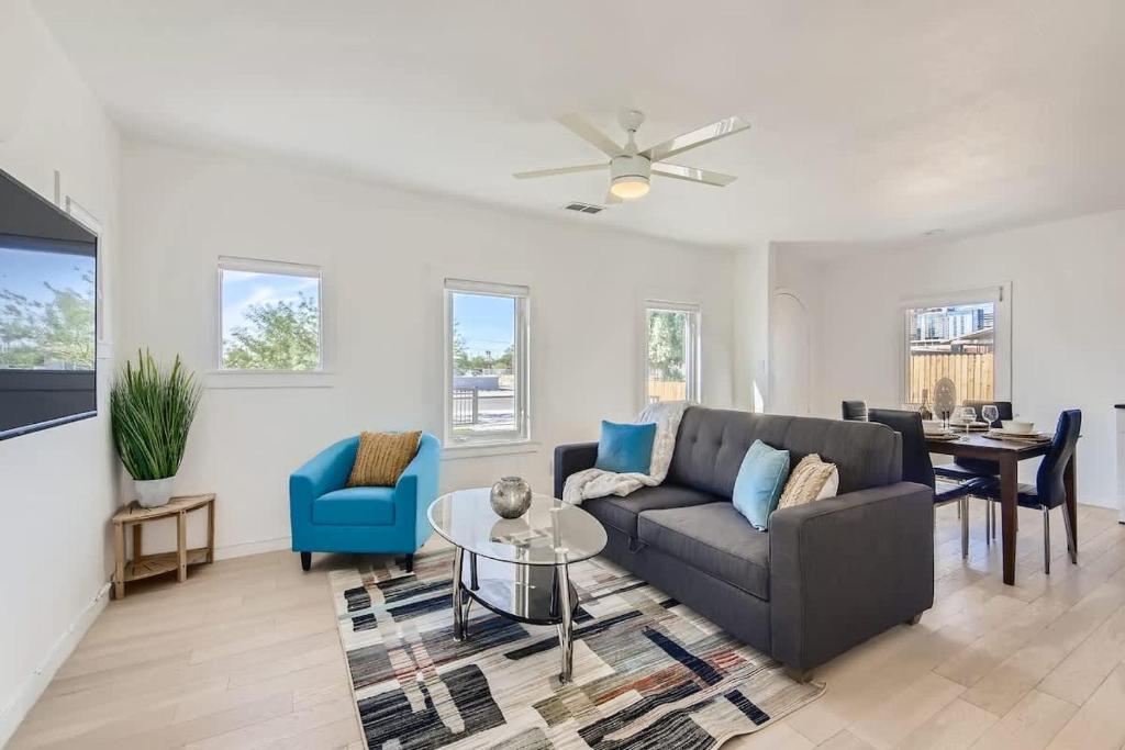 a living room with a couch and a table at Cosmopolitan Cottage in Phoenix