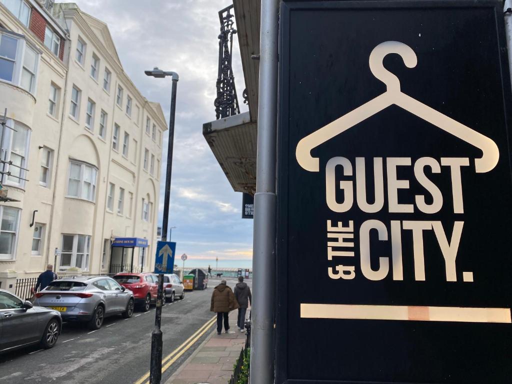 a sign for a store on a city street at Guest And The City in Brighton & Hove