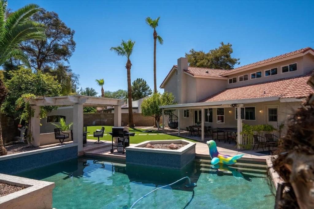 a swimming pool in front of a house at The Seaside Bohemian in Chandler