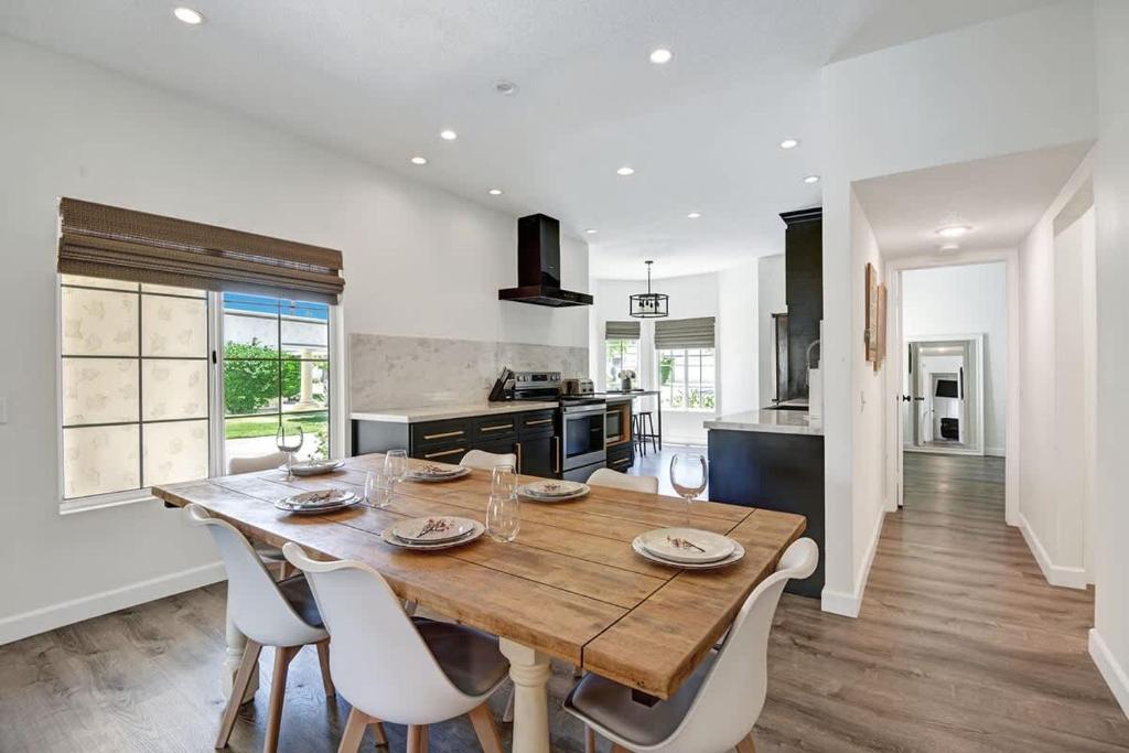 a kitchen and dining room with a wooden table and chairs at DL882 - Desert Falls Poolside Escape - Alice Lodging in Palm Desert