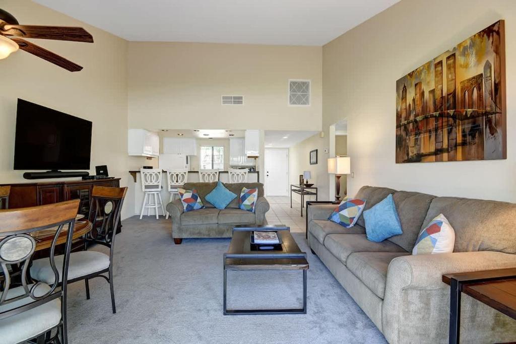 a living room with a couch and a table at PN561 - Jupiter View - Alice Lodging in Palm Desert