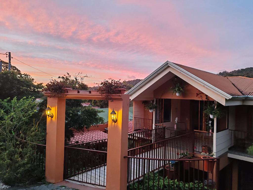 a house with an open gate at sunset at Mi Casa Su Casa Monteverde in Monteverde Costa Rica