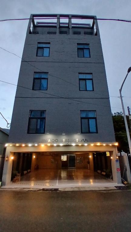 a tall building with a lot of windows at 진우 프레스티지 호텔 in Okp'o-ri