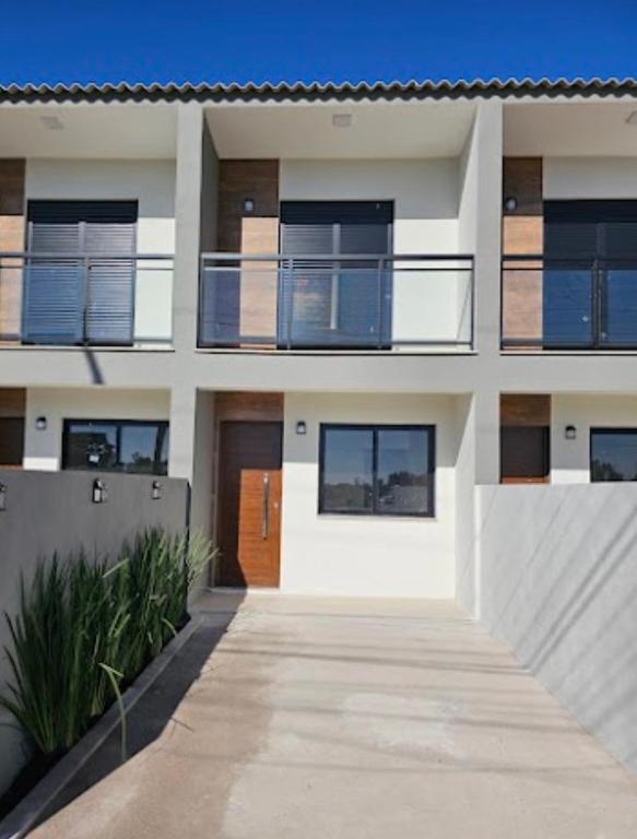 a building with a walkway in front of it at Sobrado NOVO próximo BR 290 in São Gabriel