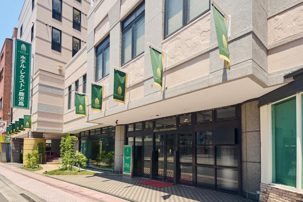 a building with green signs on the side of it at Hotel Lexton Kagoshima in Kagoshima