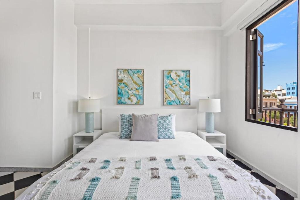a white bedroom with a large bed and a window at Mint Suite - 1 BR in Old San Juan in San Juan