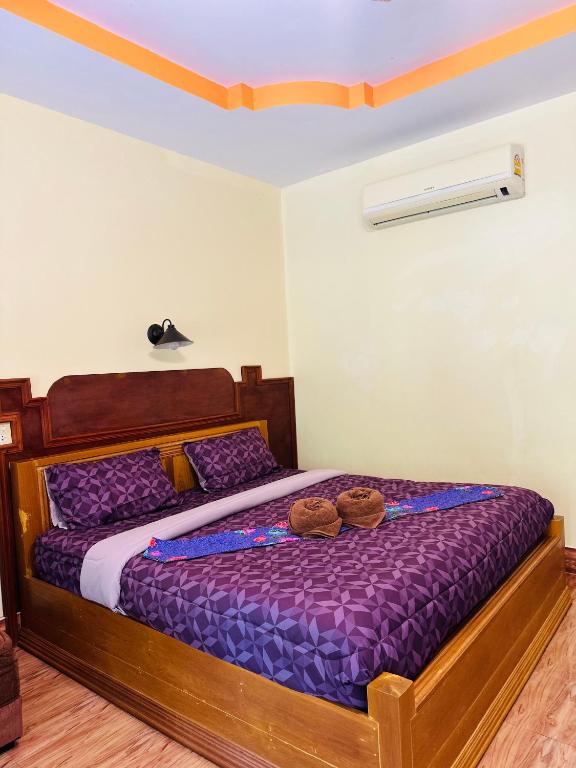 a bedroom with a bed with two donuts on it at Phu Lanta Life Resort in Ko Lanta