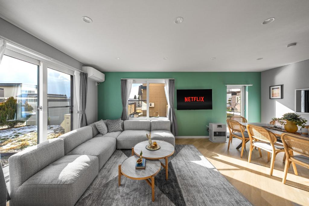 a living room with a couch and a table at The KAMUY FURANO in Nakafurano