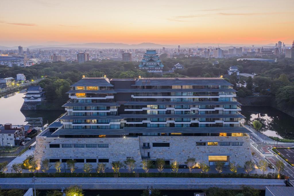 a large building with a city in the background at Espacio Nagoya Castle, The Leading Hotels of the World "LHW" in Nagoya
