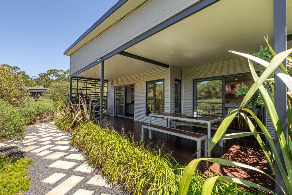 a house with a bench on the side of it at Hartzell One Seven - Private - Family Friendly in Wilyabrup