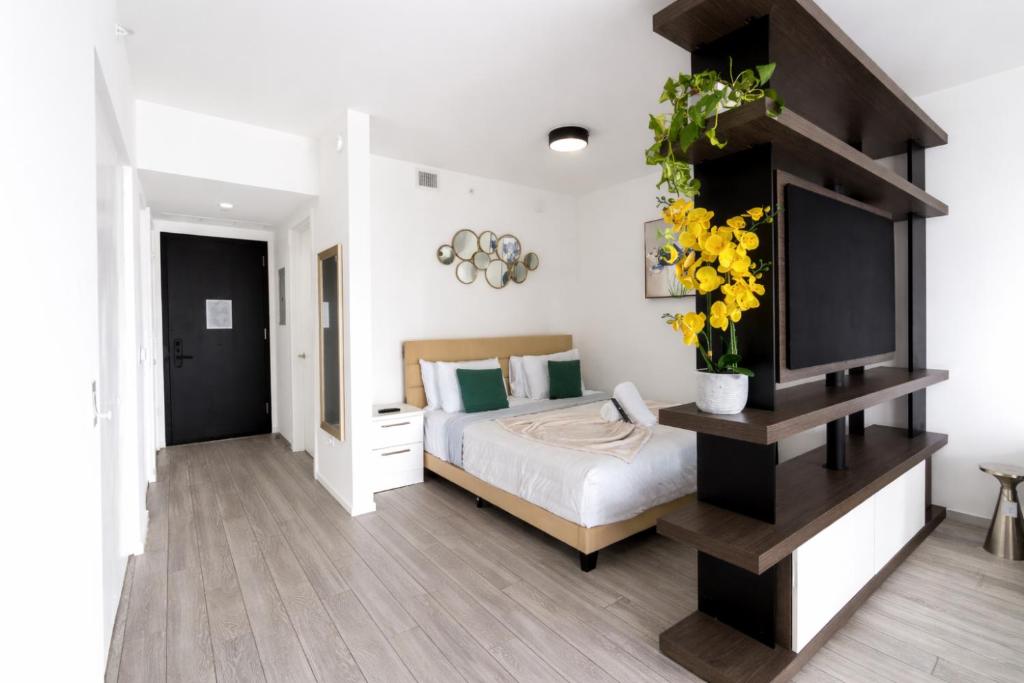 a bedroom with a bed with yellow flowers on it at Downtown Skyline Heights with Stunning Ocean View in Miami