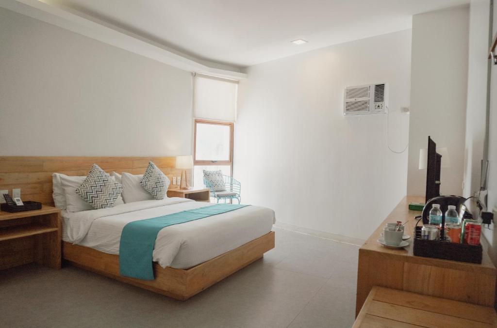 a bedroom with a bed and a table and chairs at Bay's Inn Resort in Baler