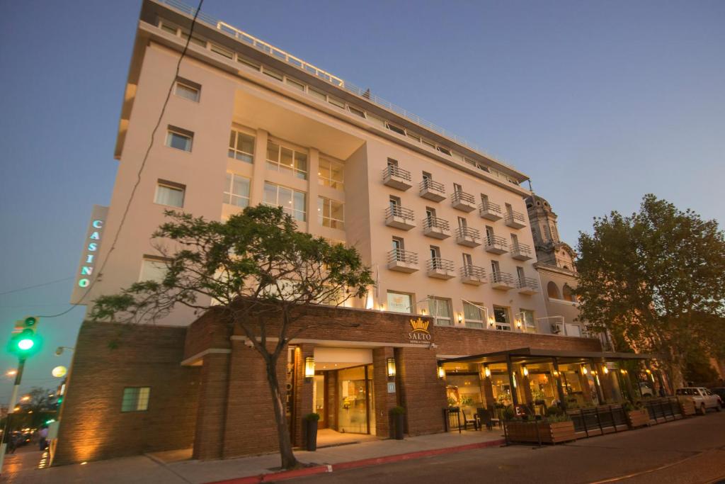 a tall white building on a city street at Salto Hotel y Casino in Salto