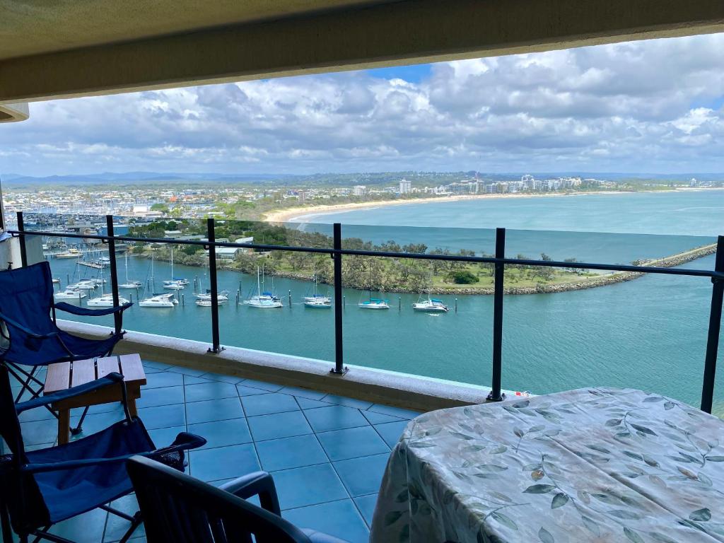 a balcony with a view of a harbor with boats at High Level with Ocean Views Everywhere in Buddina