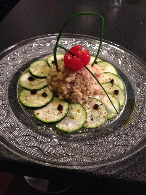 a plate of food with cucumbers and a cherry on it at Domaine de la Vivarié in Castres