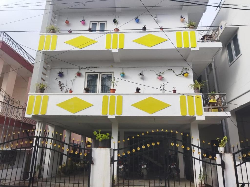 a white building with yellow arrows on it at KINGS TOWN - Serene Bliss County in Coimbatore