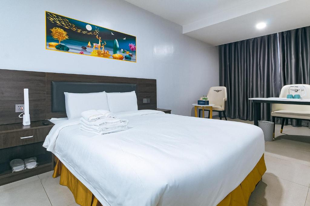 a bedroom with a large white bed in a room at Luna Hotel Pasay in Manila