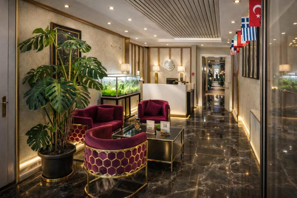 a lobby of a hotel with purple chairs and plants at Olen Uskudar Hotel in Istanbul