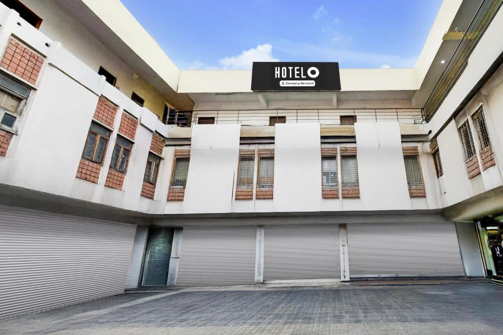 a building with a garage door and a honda sign on it at Hotel O Lakdikapul Near Birla Mandir in Hyderabad