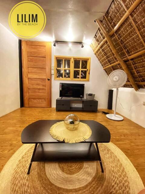 a living room with a table with a bowl on it at Duplex A- Seaside Haven Transient Inn at Caba, La Union in Caba