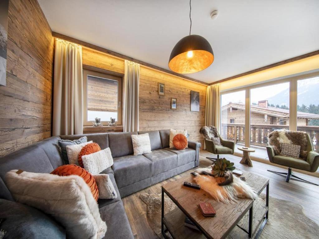 a living room with a couch and a table at Mountain Wellness stay in Neukirchen in Neukirchen am Großvenediger