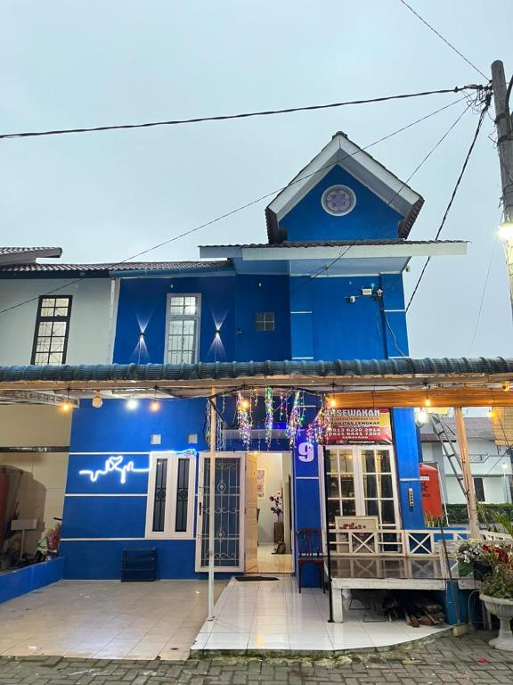 a blue building with the front of it at Villa Bukit Asri Berastagi in Berastagi